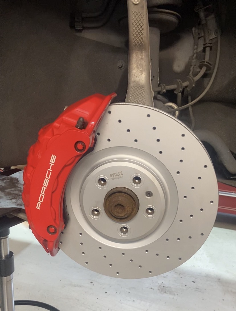 Porsche Macan brake rotor and red Porsche caliper